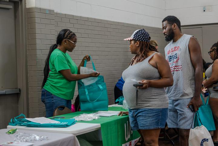 A young couple collecting information at a resource table