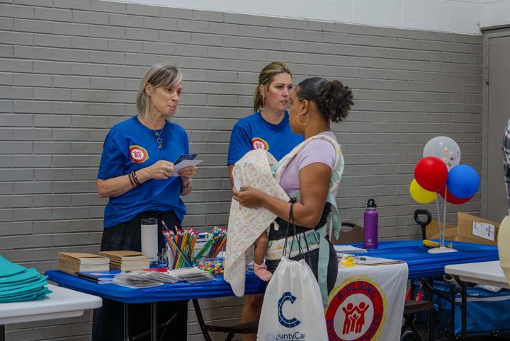 A partner organization walking a parent through its programs