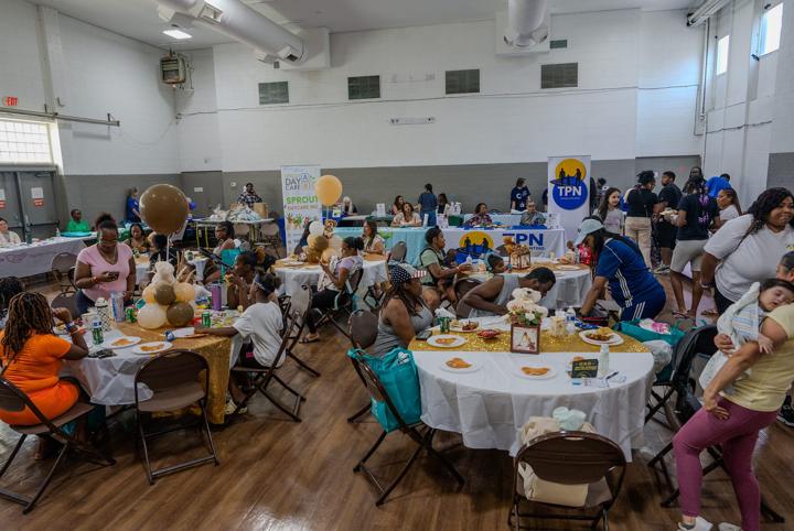Families at decorated tables during the Community Baby Shower