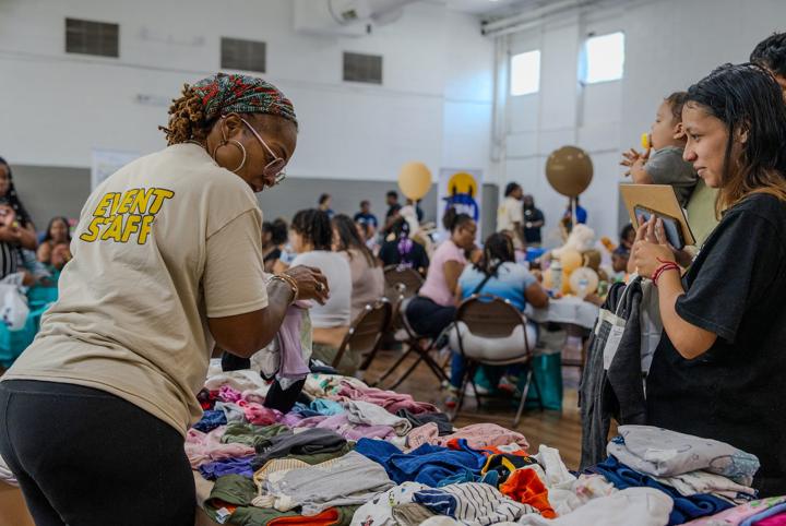 Event staff sorting clothing for families