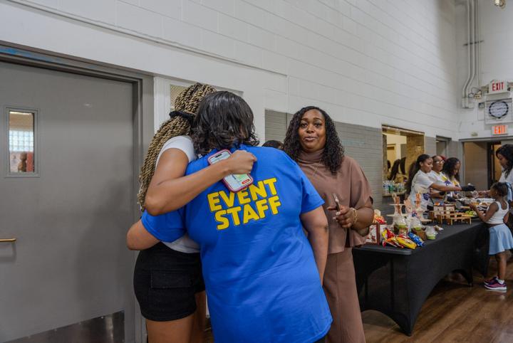 A hug between event staff and a guest