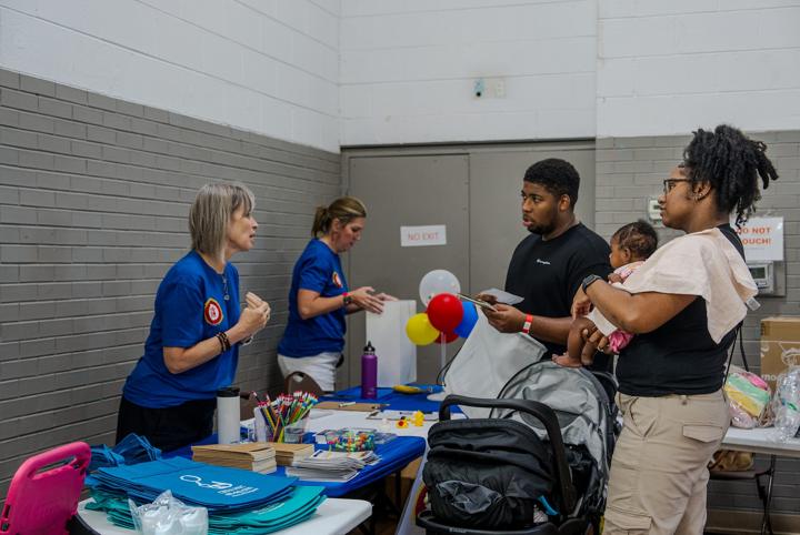 A family with their baby at the resource fair
