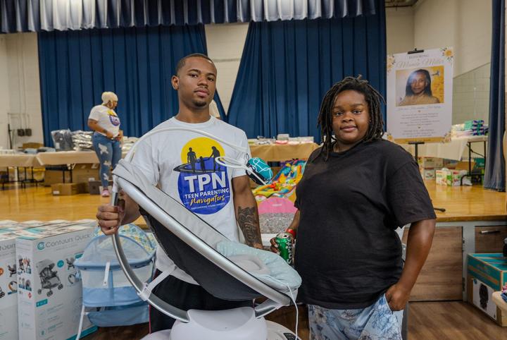 Young parents with a new infant seat