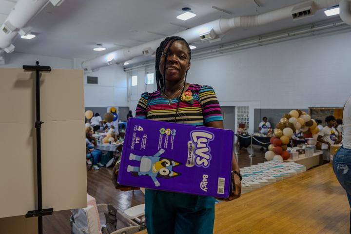 A mom with a box of diapers